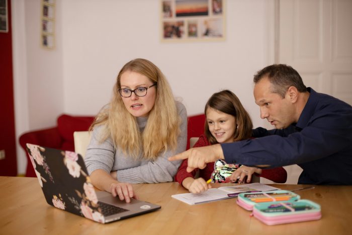 Family and daughter working together on a computer